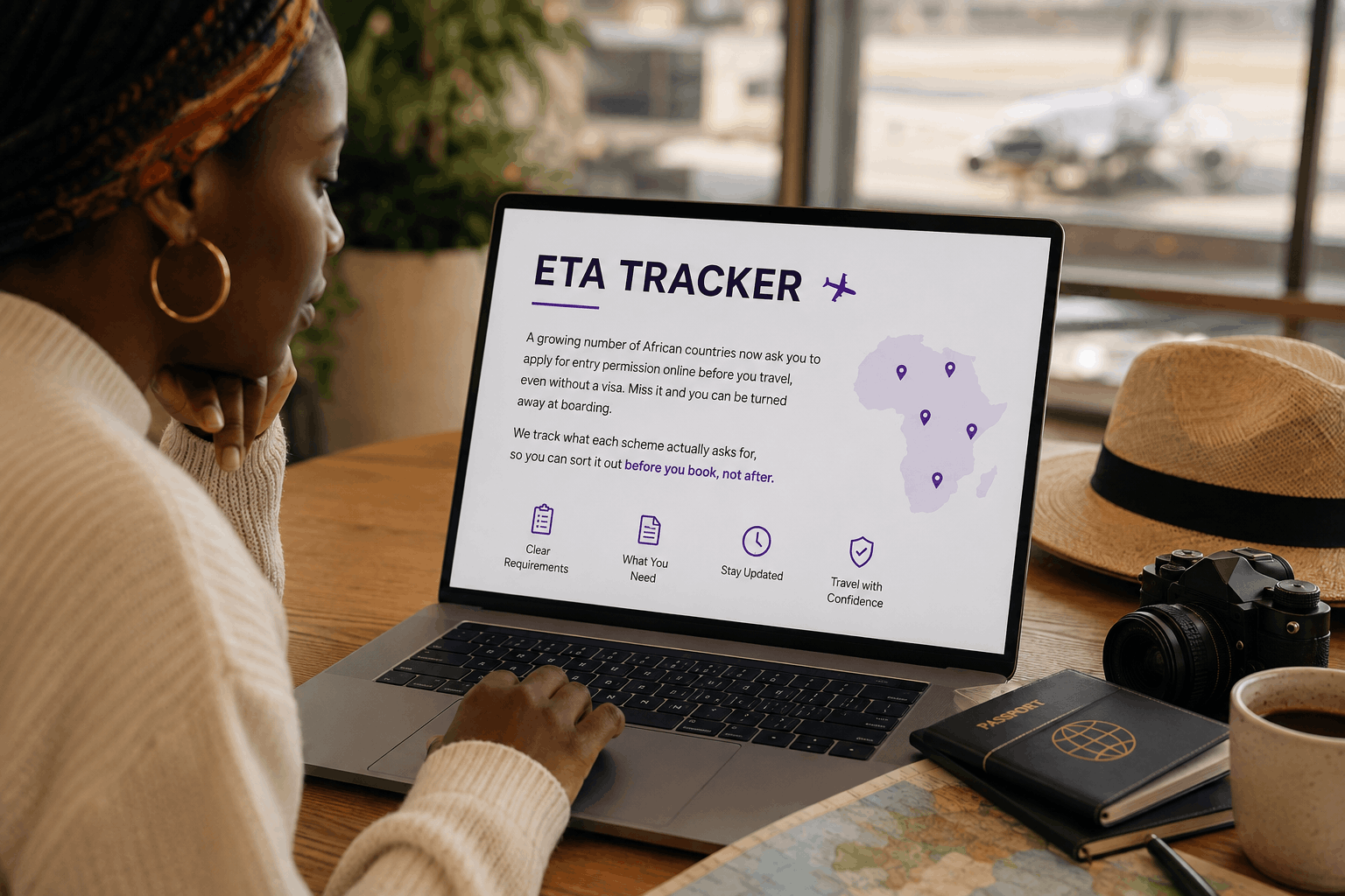 A traveller at an airport checks the Aerial View ETA Tracker on her laptop, showing a map of Africa with entry-requirement pins
